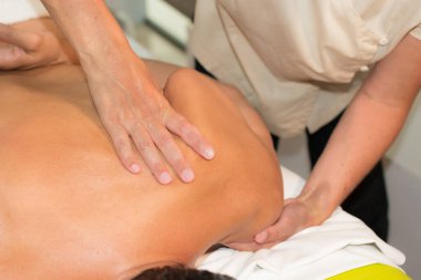 Adam sırtından masaj yaptırıyor.