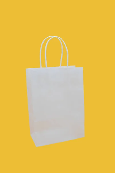 Bolsa Papel Blanco Sobre Fondo Amarillo —  Fotos de Stock