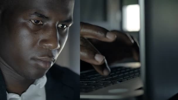 手と顔の写真を横に並べてコンピュータに取り組んでいる黒人ビジネスマンの顔を — ストック動画