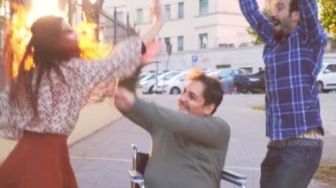 Tekerlekli sandalyede dans etmek. Genç engelli insan arkadaşlarıyla dans etmekten hoşlanır.