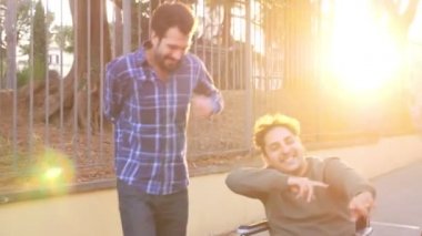 Engelli kişi dans ediyor. Arkadaşlarıyla tekerlekli sandalye dansı yapan adam eğleniyor.