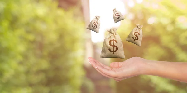 Businessman showing money bag on her hand, investment, insurance and trading abstraction