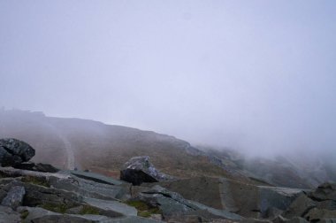 Keep going up through wind, rain,  clouds, and rocks.