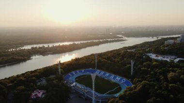 AERIAL: Sunrise over the Dnipro River and Dynamo Kyiv Lobanovskyi Stadium, Kyiv, Ukraine. Drone footage of Kyiv city at Dawn. High quality 4k footage