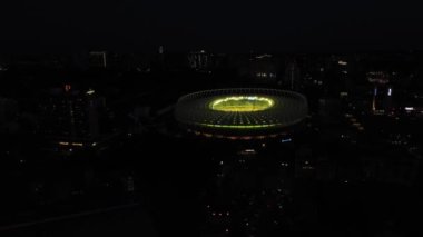 Aerial: Football stadium, Olympic stadium at night in Kiev, Ukraine. Drone footage of FC Dynamo Kyiv Stadium lighted at night. High quality 4k footage