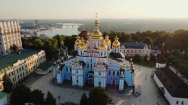 Fly over St. Michaels Golden-Domed Monastery on Mykhailivska Square to Dnipro River at Sunrise, Kyiv, Ukraine. High quality 4k footage