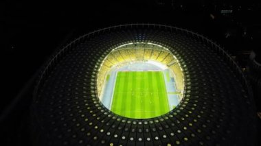 Aerial: Football stadium, Olympic stadium at night in Kiev, Ukraine. Drone footage of FC Dynamo Kyiv Stadium lighted at night. High quality 4k footage