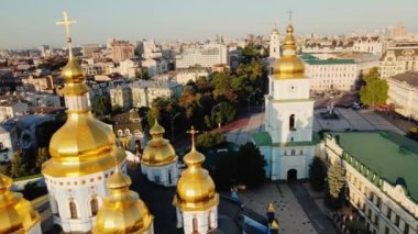Flying Over the Golden Domes of St. Michaels Monastery on Mykhailivska Square at the banks of Dnipro River at Sunrise, Kyiv, Ukraine. High quality 4k footage