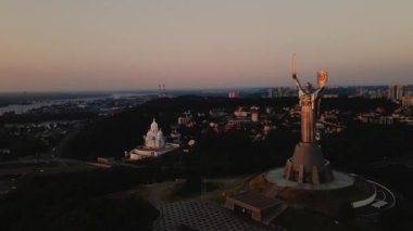 Fly around Motherland Monument to Dnipro River at dawn in Kyiv, Ukraine. Cinematic Drone footage. High quality 4k footage