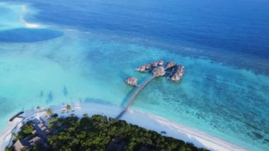 Aerial view of two groups of water bungalows in The Maldives. Luxury resort on Vakkaru Island, Maldives. High quality 4k footage