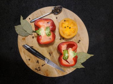 Red perer and yellow tomato, knife and spoon on the desk Top view. Flat Lay