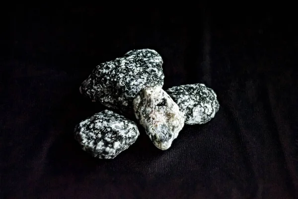 composition with stone on black background