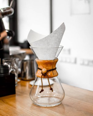 Chemex for pour over brewed coffee in coffee shop. Filter coffee in a coffee shop. Barista showcase.