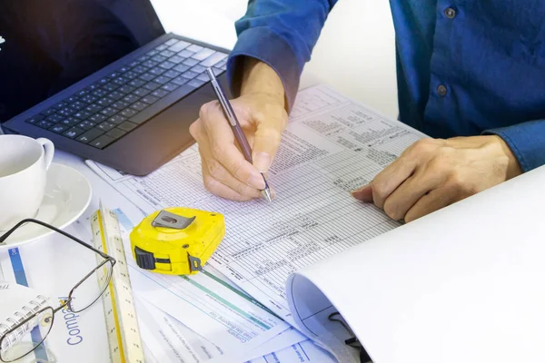 Project engineers check the construction documents of various systems.,Building construction and system work,Real estate and building business