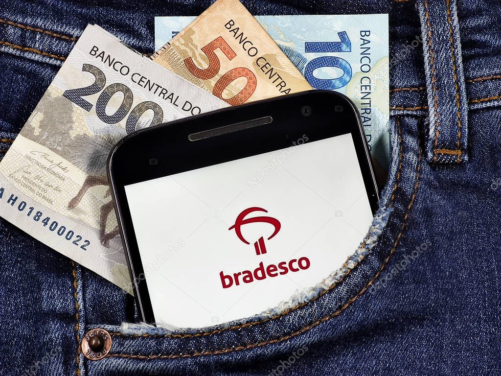 Smartphone with Banco Bradesco application logo of the Bradesco and Visa flags. Digital payment system. Bradesco is a Brazilian bank, incorporated as a corporation.