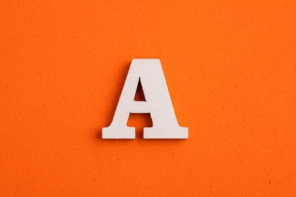 White Wooden Capital Letter Orange Foamy Background — 스톡 사진