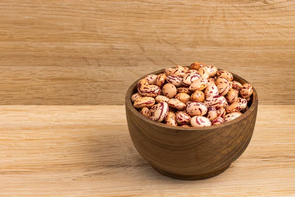 Dried pinto beans in the wooden bowl - Phaseolus vulgaris