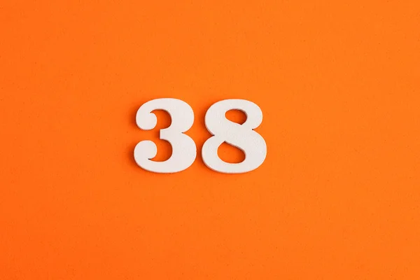 White Wooden Number Eva Rubber Orange Background — стоковое фото