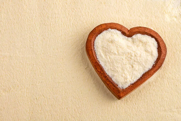 Powdered milk with nutrients in the heart shaped bowl