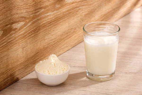 Glass of fresh liquid and powdered milk