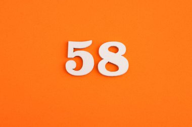 White wooden number 58 on eva rubber orange background