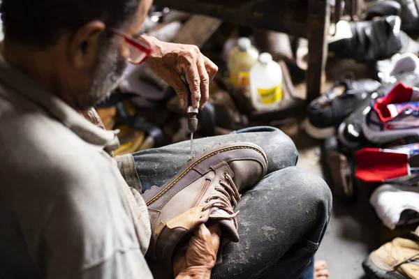 Yolombo, Antioquia - Colombia. July 24, 2022. The person whose trade is the manufacture and repair of footwear is called a shoemaker.