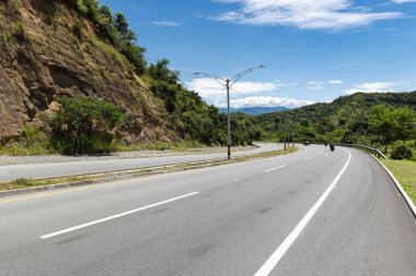 Double carriageway west of the department of Antioquia, Colombia. Landscapes with dual carriageway, mountains and blue sky