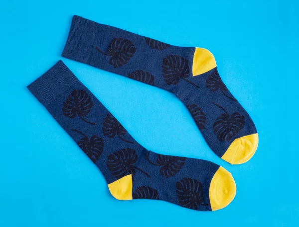 Sock Monstera Leaves Blue Yellow Light Blue Background — Zdjęcie stockowe