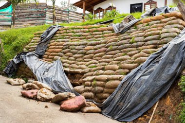 Retaining wall with sacks full of earth