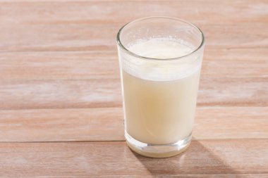 Glass of fresh liquid and powdered milk