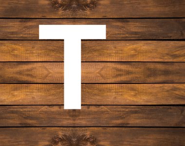 Tahta zemin üzerinde beyaz delikte T harfi.