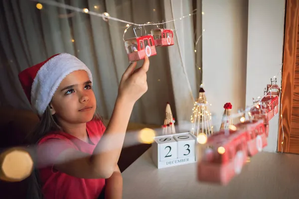 Kid by original advent calendar, ski resort made with toilette paper rolls. Magic Christmas holiday — Stock Photo, Image