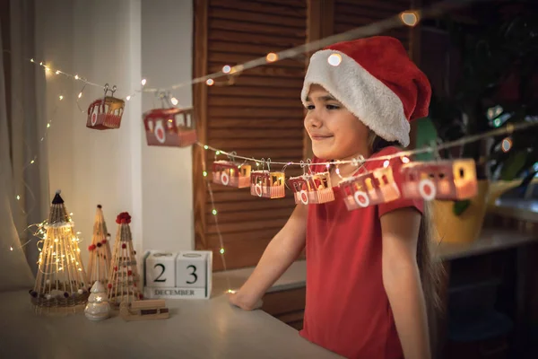 Kid by original advent calendar, ski resort made with toilette paper rolls. Magic Christmas holiday — Stock Photo, Image