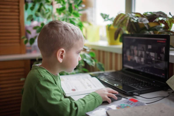 Afstandsonderwijs. Schattig schoolkind dat huiswerk studeert tijdens online les thuis, sociale afstand — Stockfoto