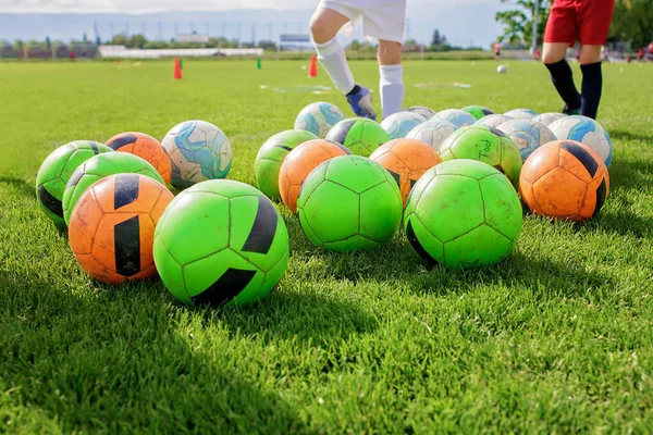 Soccer gears on green grass prepared for training in kids football academy. Popular sport activity — Stock Photo, Image