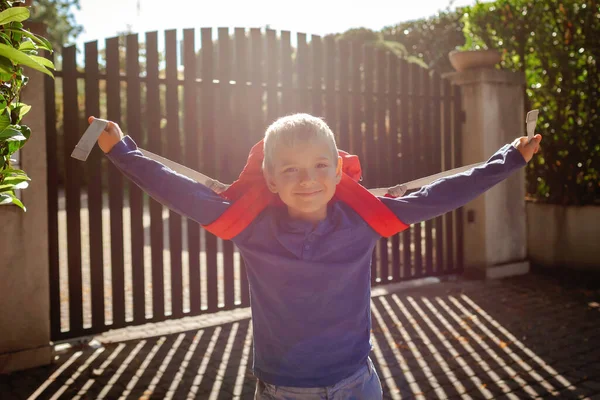 Back to school. Happy boy with backpack, primary school kids, going to school from the home at the first day, study and education, return after vacations, lifestyle