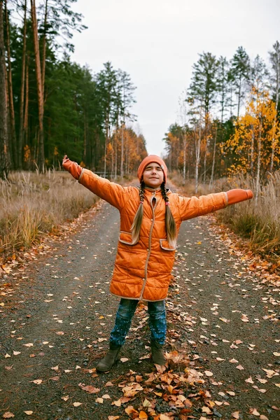 Happy Ten Years Girl Orange Coat Outstretched Arms Enjoys Fresh — Foto de Stock