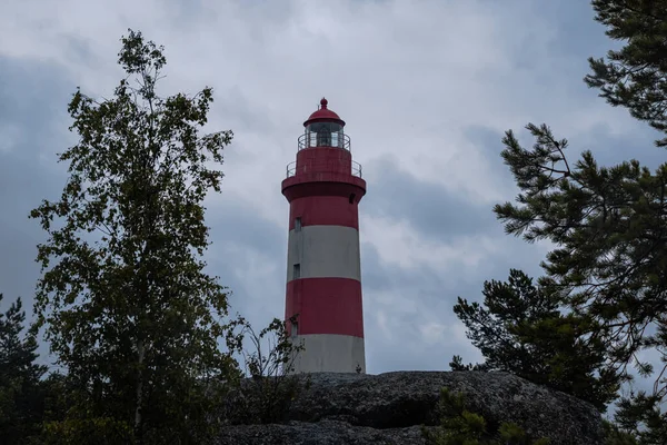 a beautiful lighthouse with a large white-blue-red lighthouse on a rainy day.