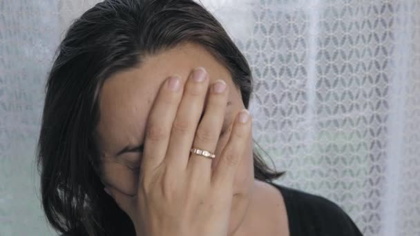 Upset Caucasian Woman Stands Window Touches Her Face Her Hand — Vídeo de Stock