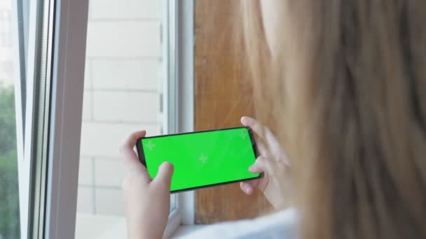 Teenage Girl Holds Phone Green Screen Her Hands While Standing — Vídeo de Stock
