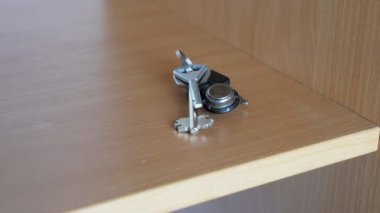 A womans hand takes a bunch of keys from a shelf. The girl leaves the apartment and takes the keys to close the door. High quality 4k footage