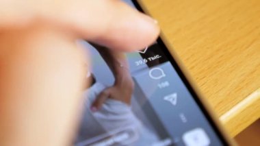 A person scrolls through a video on social networks and likes it. The girl watches short videos on the Internet. A woman is watching Reels. High quality 4k footage