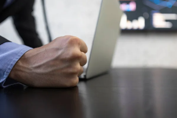 Close up of a fist hitting the desktop in a business concept