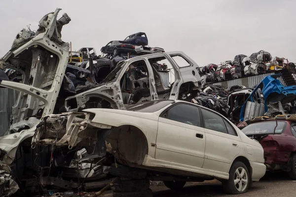 Car Cemetery - cars waiting to be recycle in junkyard in Turkey, Ankara - stacked cars in Auto graveyard