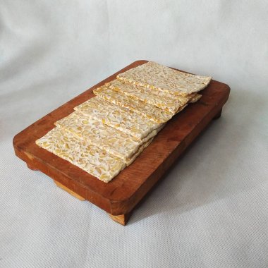 Raw Tempe, Tempe or Tempeh made from fermented soybeans which are rich in nutrients and protein.