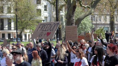 London, UK - April 24, 2021: 'Unite for Freedom' protest by covid-19 sceptics, demonstrators opposing lockdown, vaccination, mask-wearing and health passports.