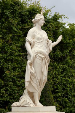VERSAILLES / FRANCE - June 16, 2019: The Daybreak - Marsy (1680) statue in the park of Versailles palace near Paris, France