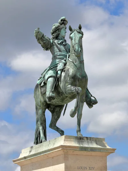 Bronze statue of Louis XIV (Sun King) in front of the palace of Versailles near Paris