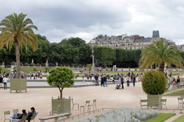 Paris / France - June 08, 2019: people relaxing in Luxembourg Gardens (Jardin du Luxembourg) on a summer day