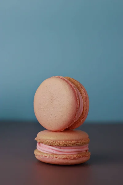 macaroons with pink buttercream blue background with copy space